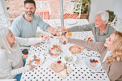 Buy stock photo Shot of a family toasting with wine glasses at home