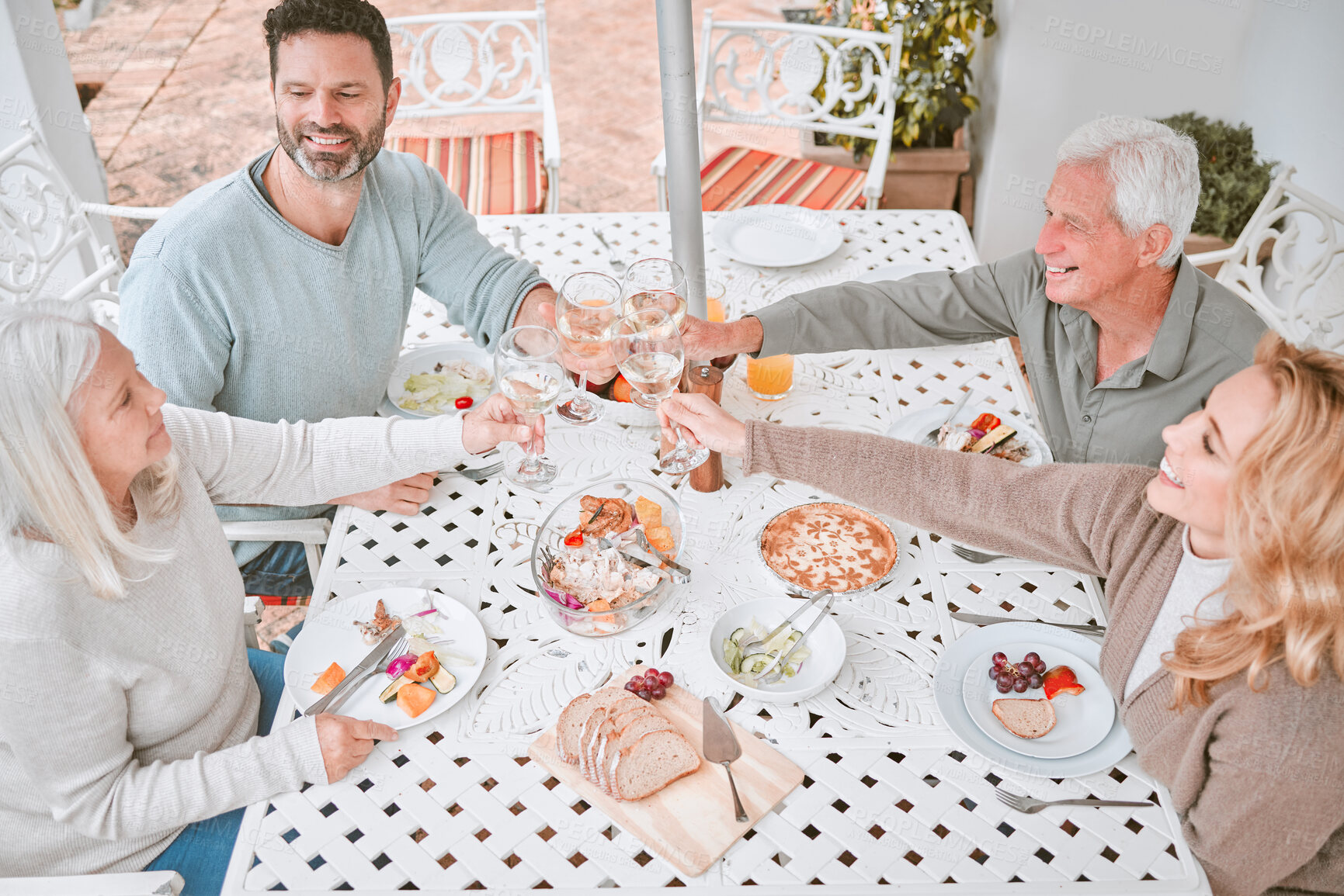 Buy stock photo Family, wine and cheers with glass on patio for celebration, holiday or bonding together. Top view, toast and people with alcohol in backyard for gathering, sharing meal or weekend lunch at home