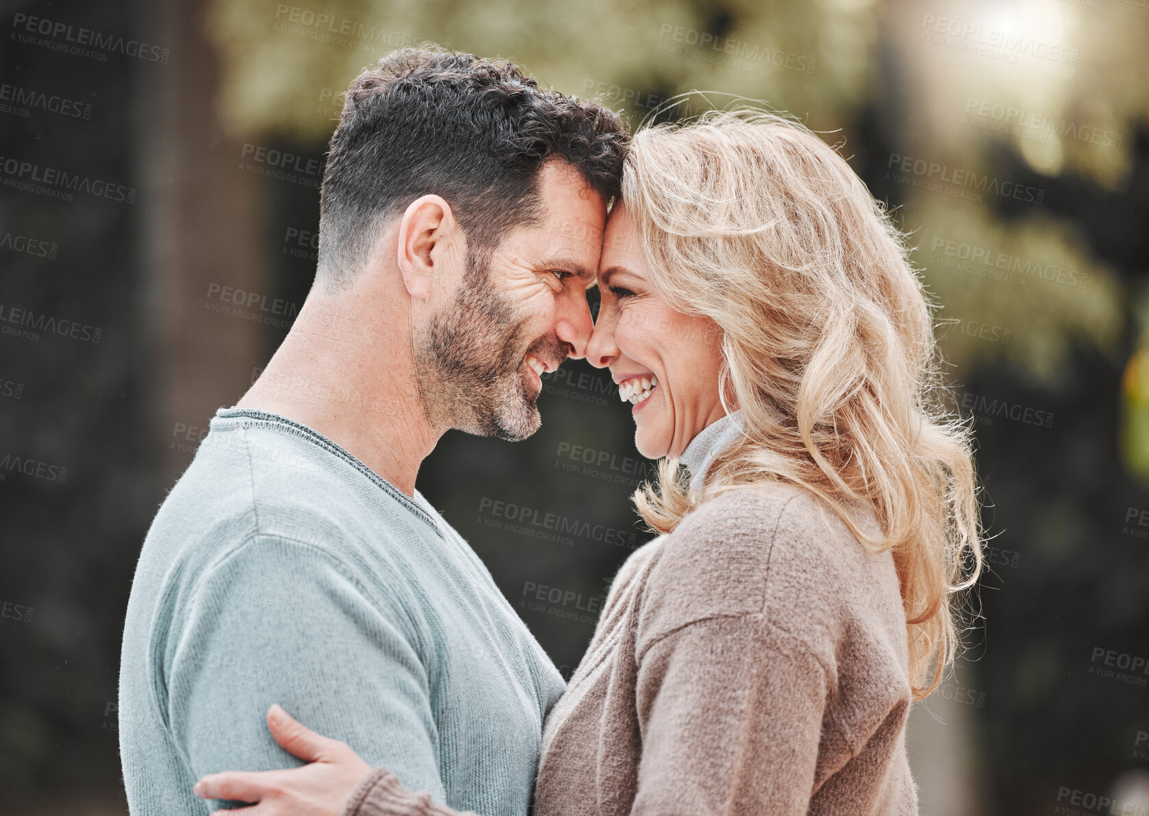 Buy stock photo Mature couple, forehead and outdoor hug for support, love and affection for spouse on holiday. Happy people, trust and vacation for bonding in nature, embrace and countryside security in commitment