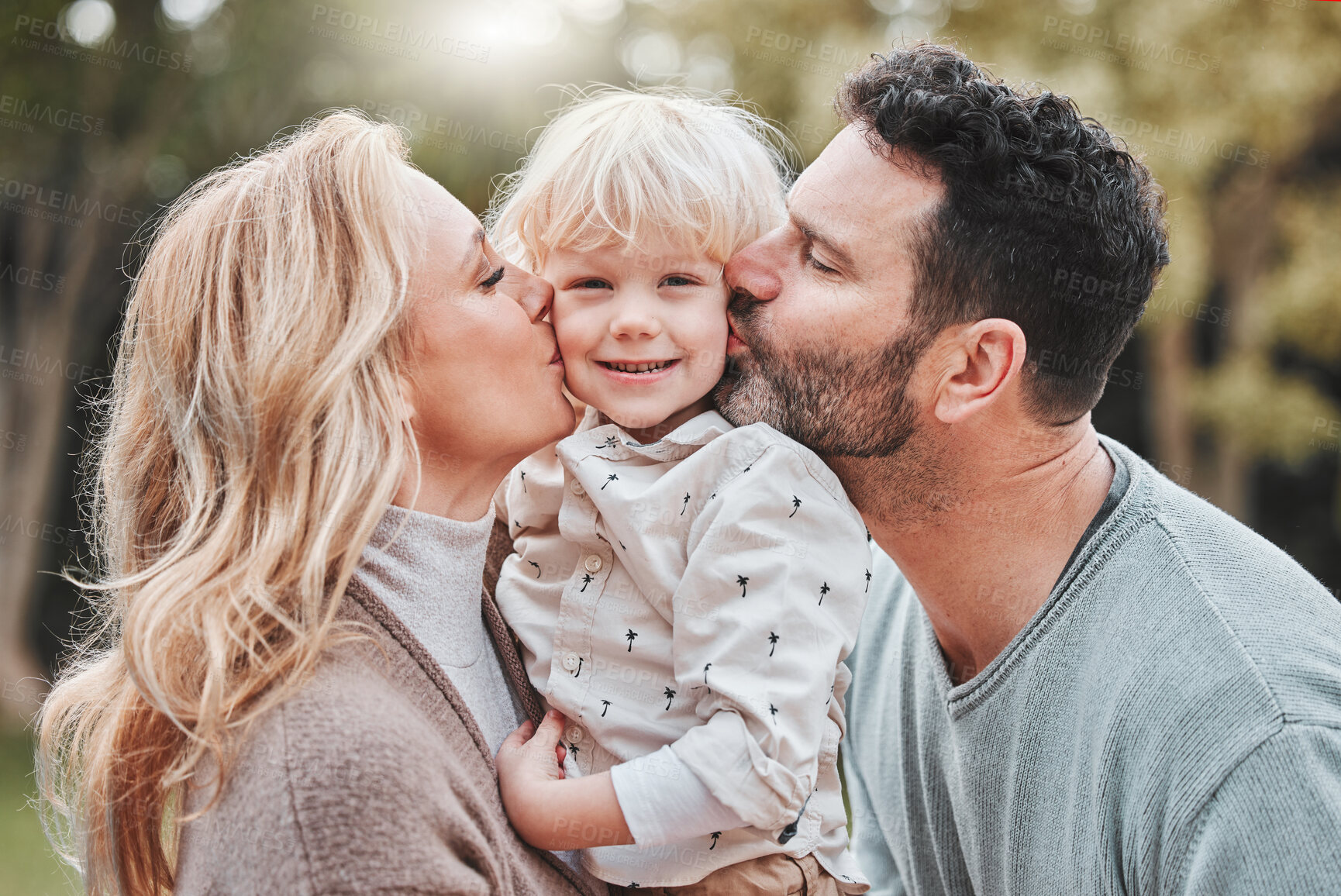 Buy stock photo Portrait, parents and child in garden with kiss, embrace and smile for outdoor bonding together in nature. Mom, dad and son in backyard with hug, care or love for happy family in park for weekend fun