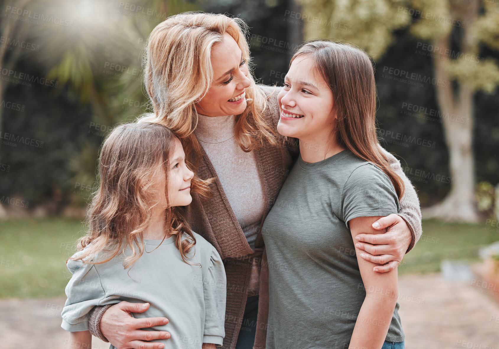 Buy stock photo Hug, mom and children in garden with smile, love and support for outdoor bonding together in park. Mother, teen girl and kids in backyard with embrace, care and weekend fun in nature for happy family