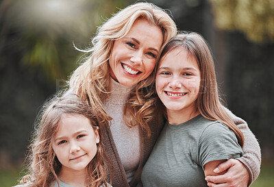 Buy stock photo Shot of a woman spending time outdoors with her two daughters
