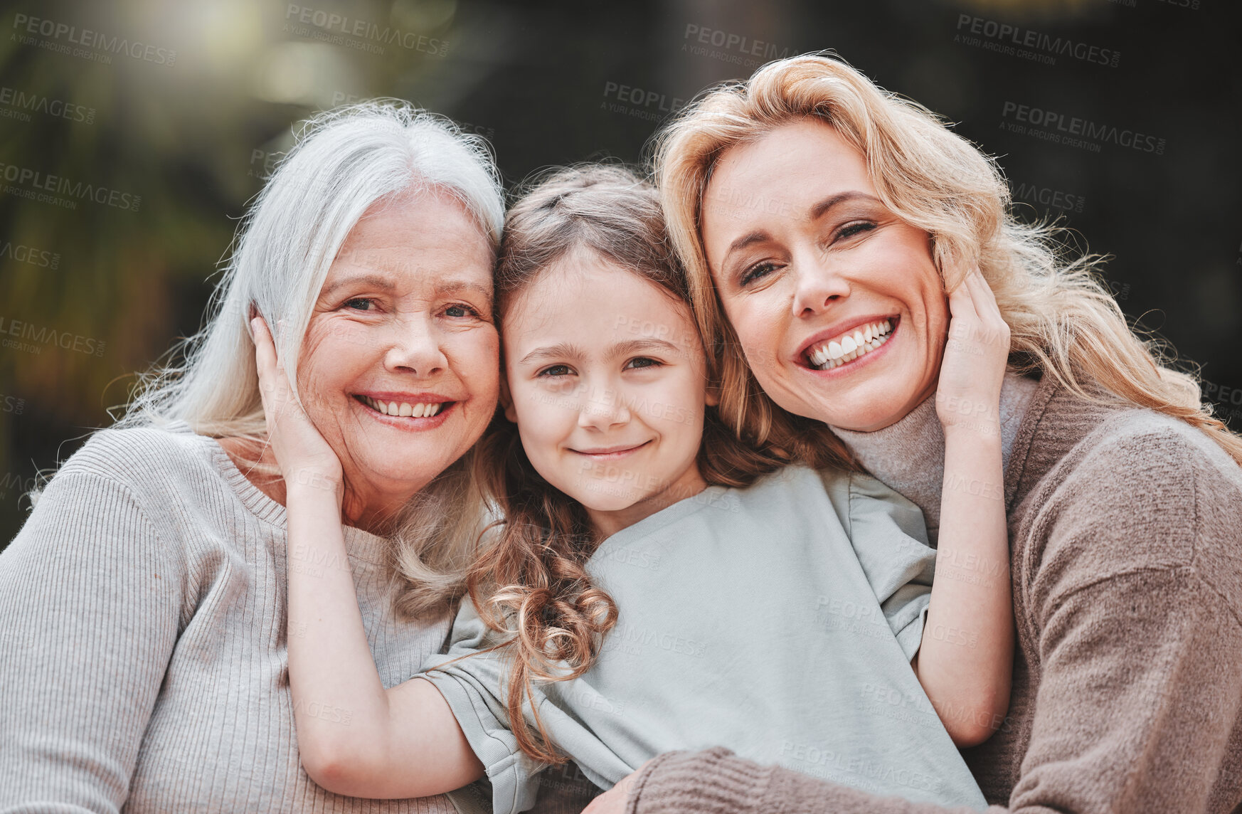 Buy stock photo Shot of a young girl posing outside with her mother and grandmother