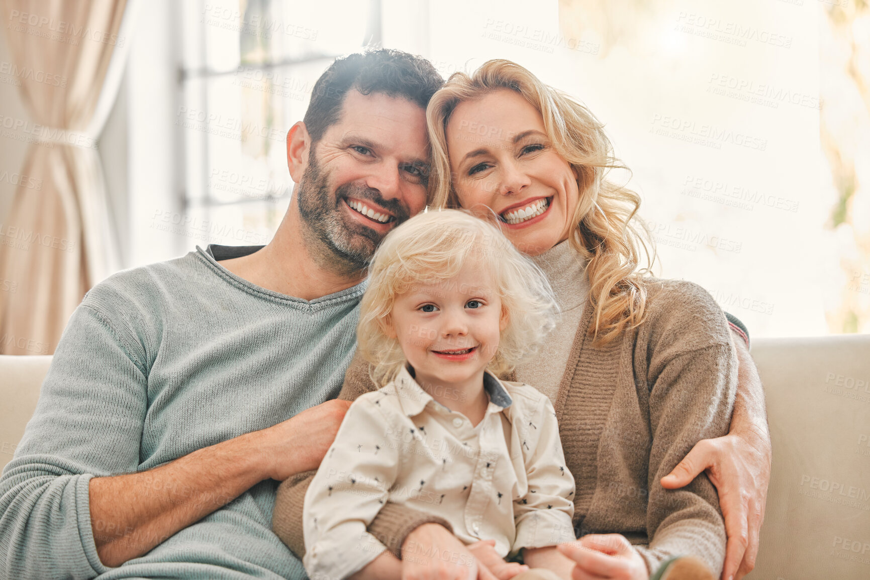 Buy stock photo Portrait, happy family and kid with parents in home to relax, care or bonding together. Face, mother and father with boy child in living room for support, love and connection for relationship on sofa