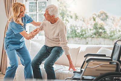 Buy stock photo Shot of a young nurse helping her elderly male patient stand up