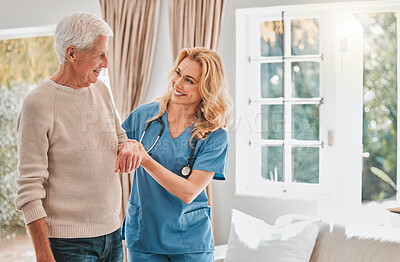 Buy stock photo Shot of a female nurse helping her elderly male patient