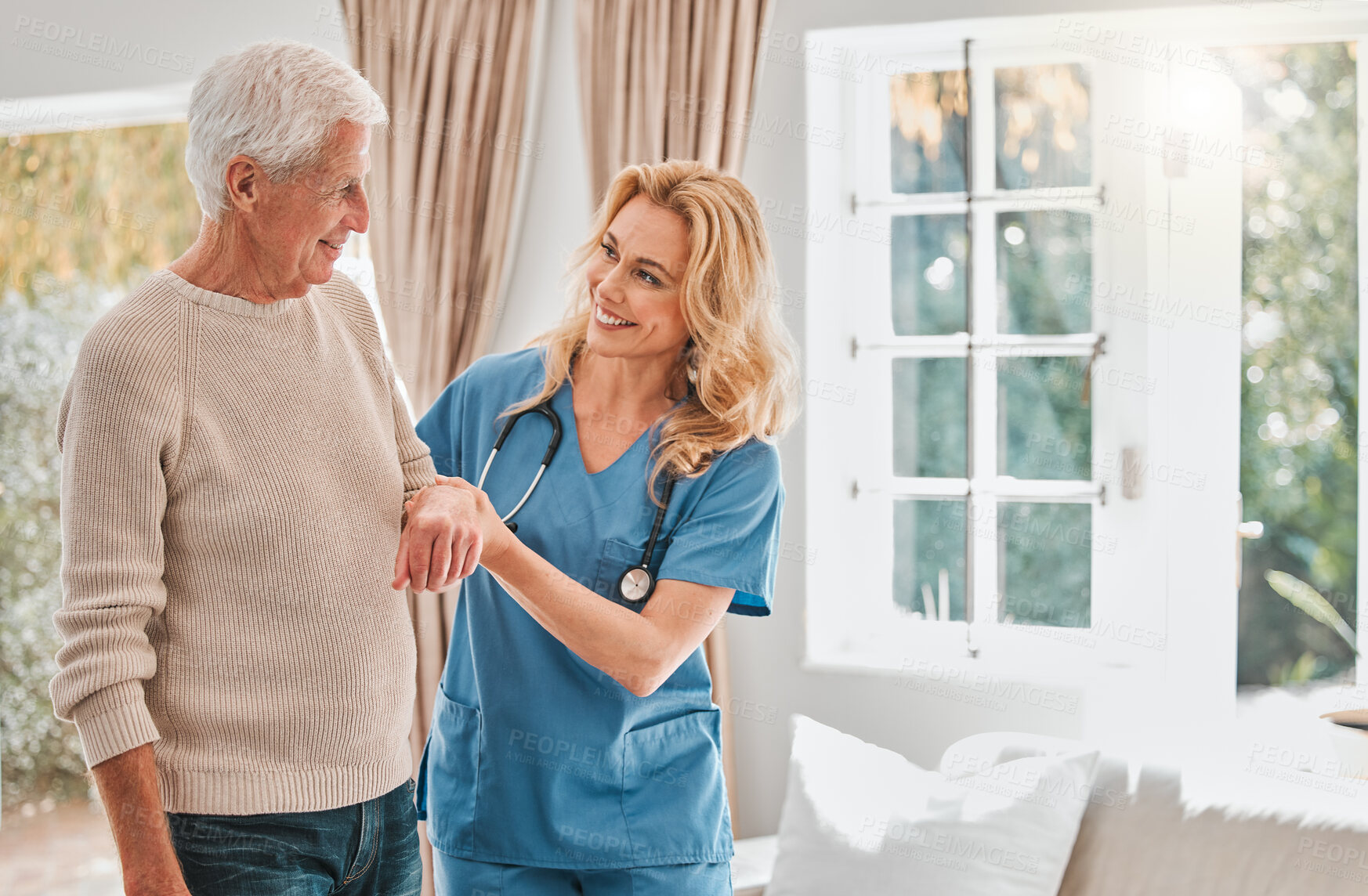 Buy stock photo Shot of a female nurse helping her elderly male patient