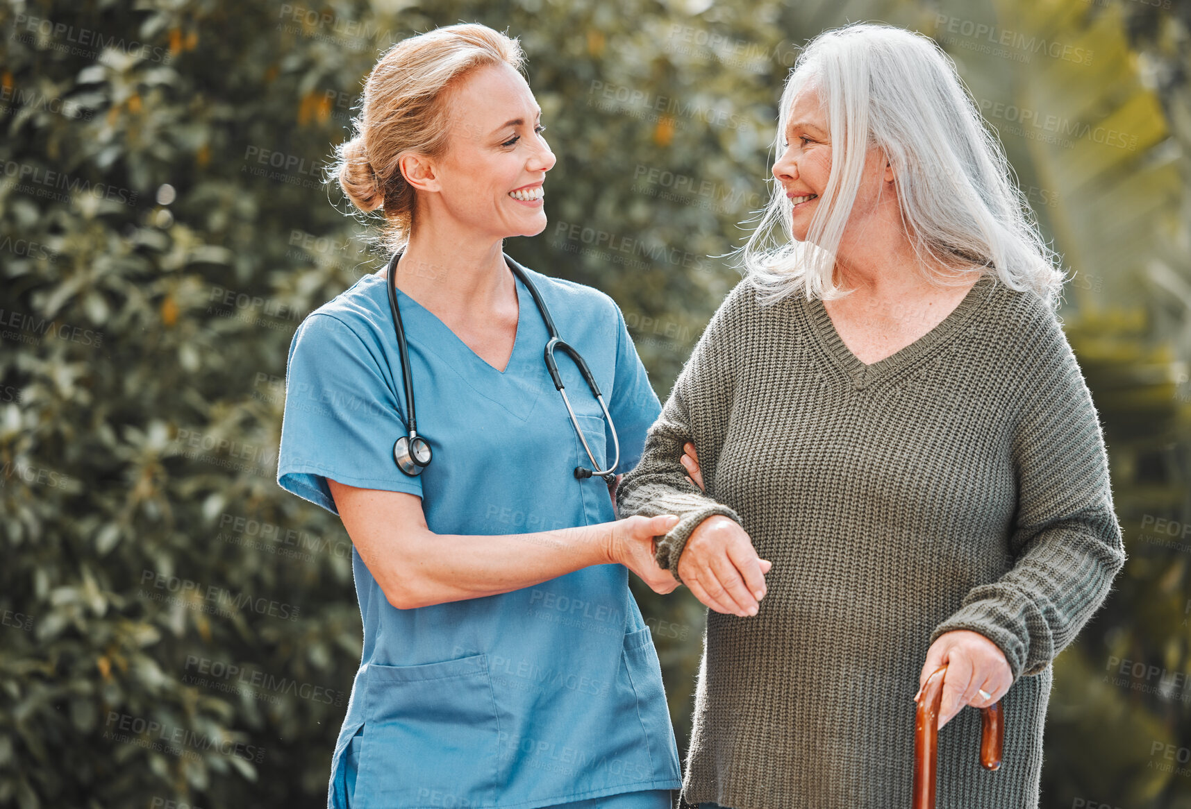 Buy stock photo Support, care and caregiver walking senior woman in a garden to relax, wellness and morning exercise in the lawn. Trust, nursing home and nurse help elderly person happy and smile for an outdoor walk