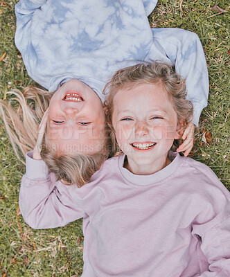 Buy stock photo Shot of two adorable little girls having fun in a garden