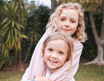 Buy stock photo Shot of two adorable little girls having fun in a garden