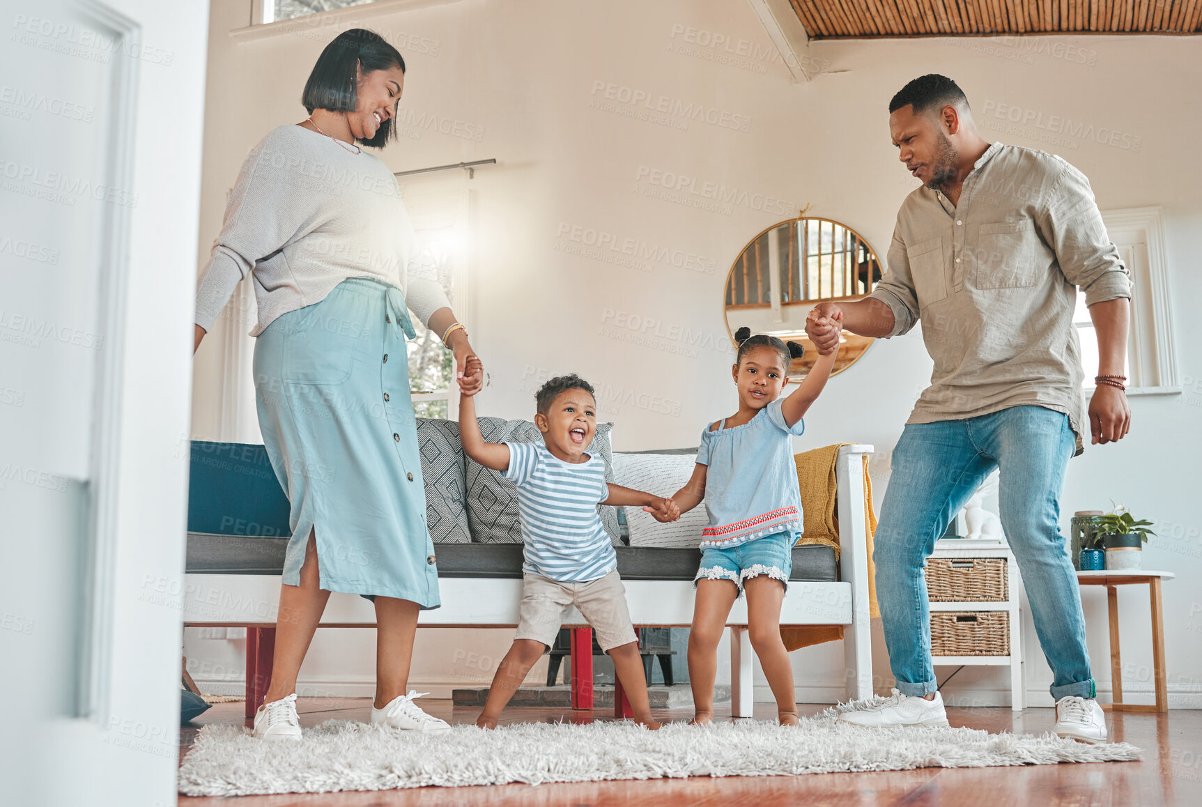 Buy stock photo Dance, love and smile with family in living room of home together for bonding, excitement or fun. Child development, energy or music with mother, father and sibling kids in apartment for movement