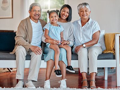 Buy stock photo Shot of a mature couple bonding with their daughter and grandchild at home