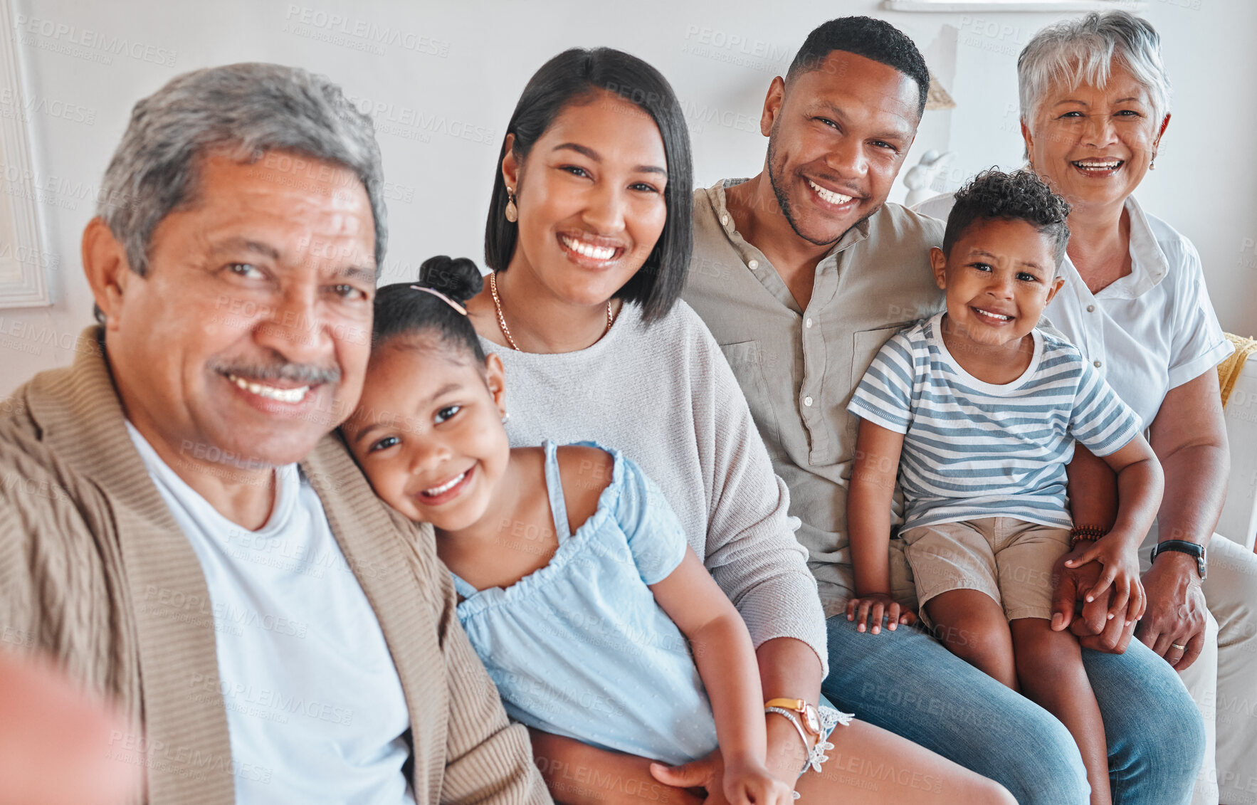 Buy stock photo Portrait of a family with their grandparents bonding together on the couch at home