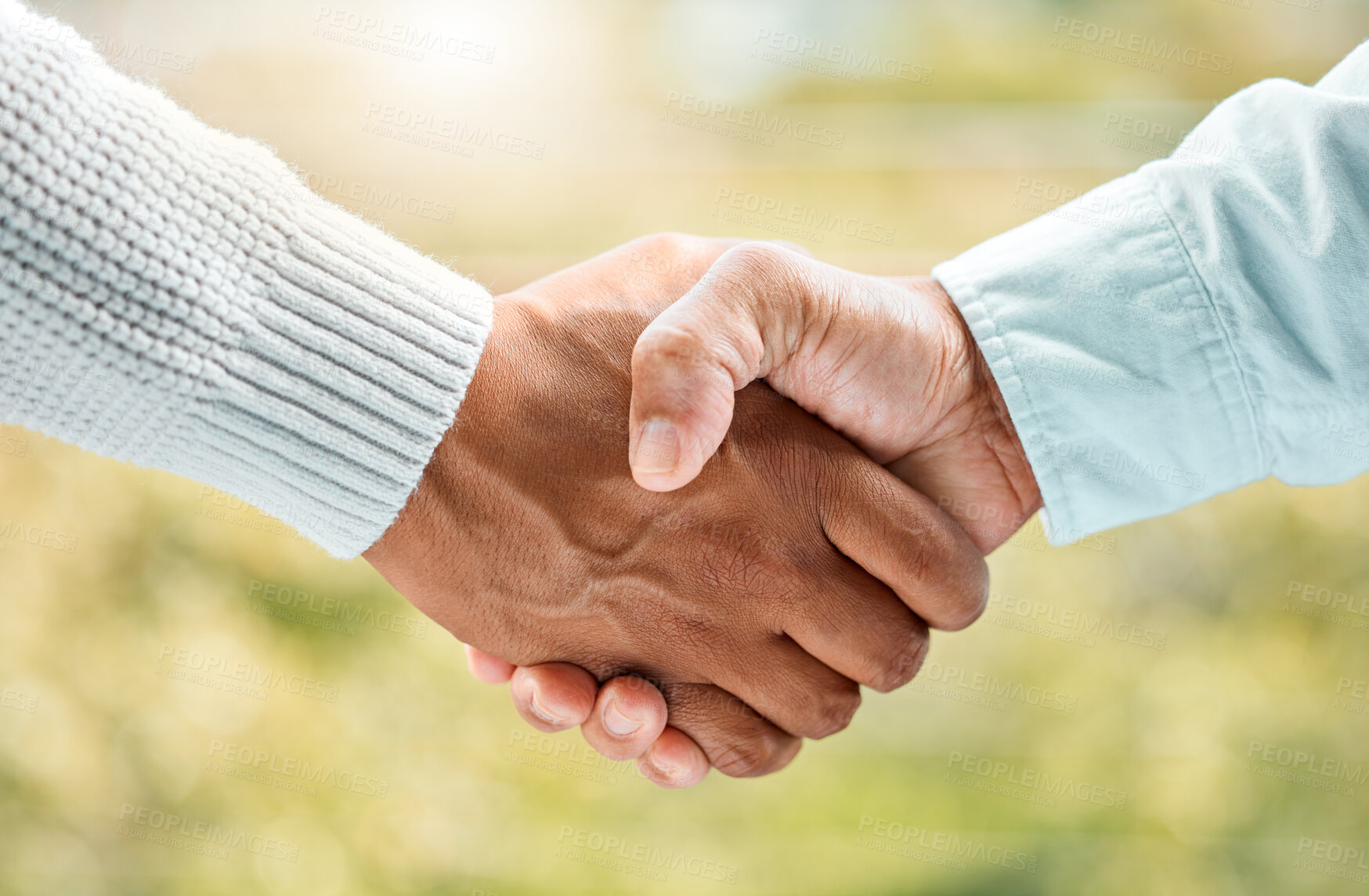 Buy stock photo Shot of two unrecognizable men shaking hands outside