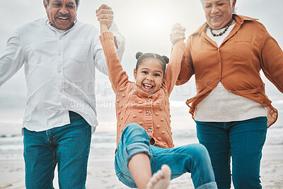 Buy stock photo Cropped shot of an adorable little girl being swung by her grandparents on the beach