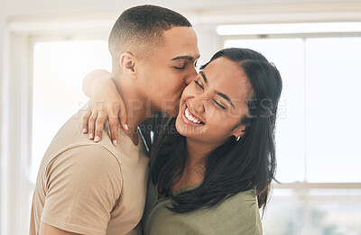 Buy stock photo Couple, love and kiss in home for happy romance, intimacy and relax while bonding together. Young man, woman and kissing partner in relationship, quality time and smile for care, trust and happiness