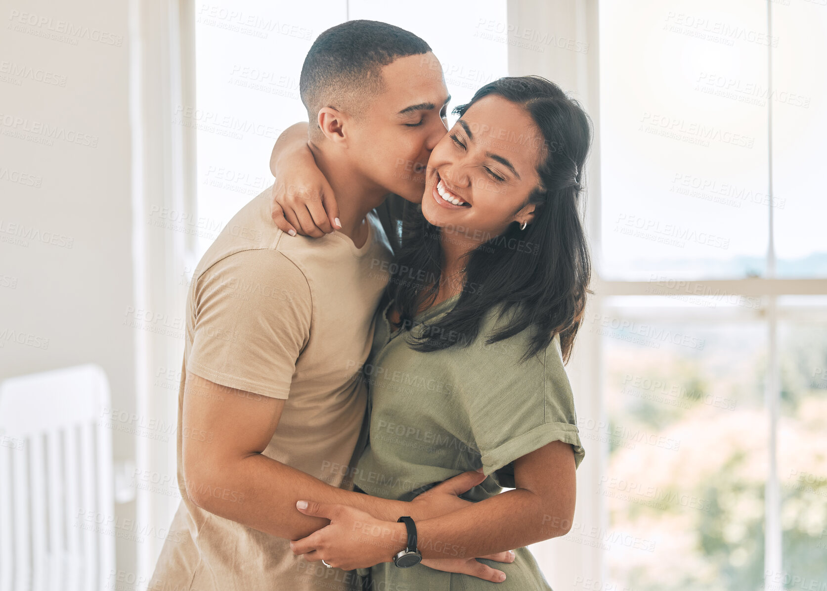 Buy stock photo Happy couple, kiss and hug in home of love, intimacy and relax for romance, bonding and trust together. Young man, woman and kissing partner for quality time, care or happiness in loving relationship