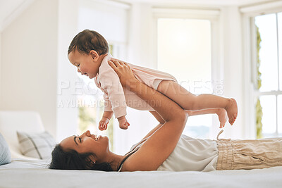 Buy stock photo Mother, lifting baby and bedroom in family home for bonding, security or quality time. Happy woman or mom and girl child relax together on bed for development, trust and support or care for happiness