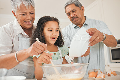 Buy stock photo Shot of grandparents baking with their granddaughter