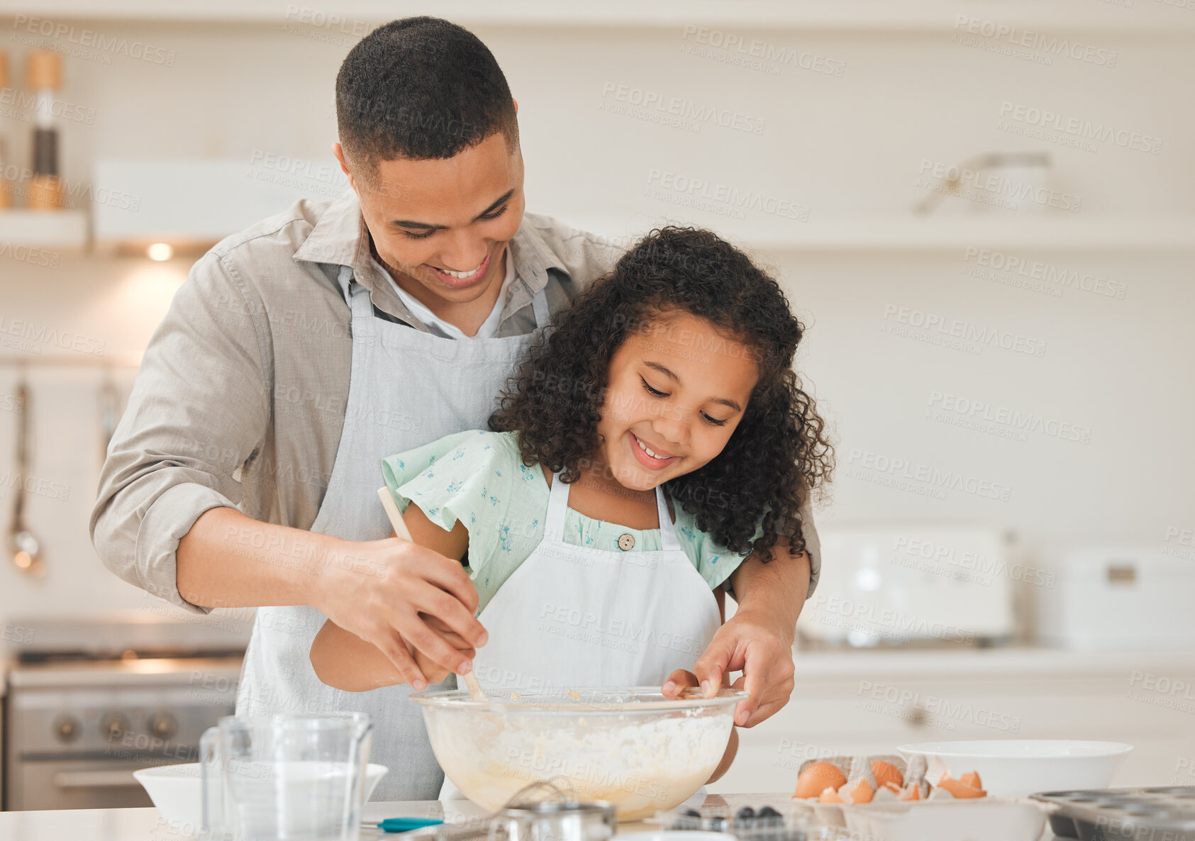 Buy stock photo Shot of a young father helping his daughter bake