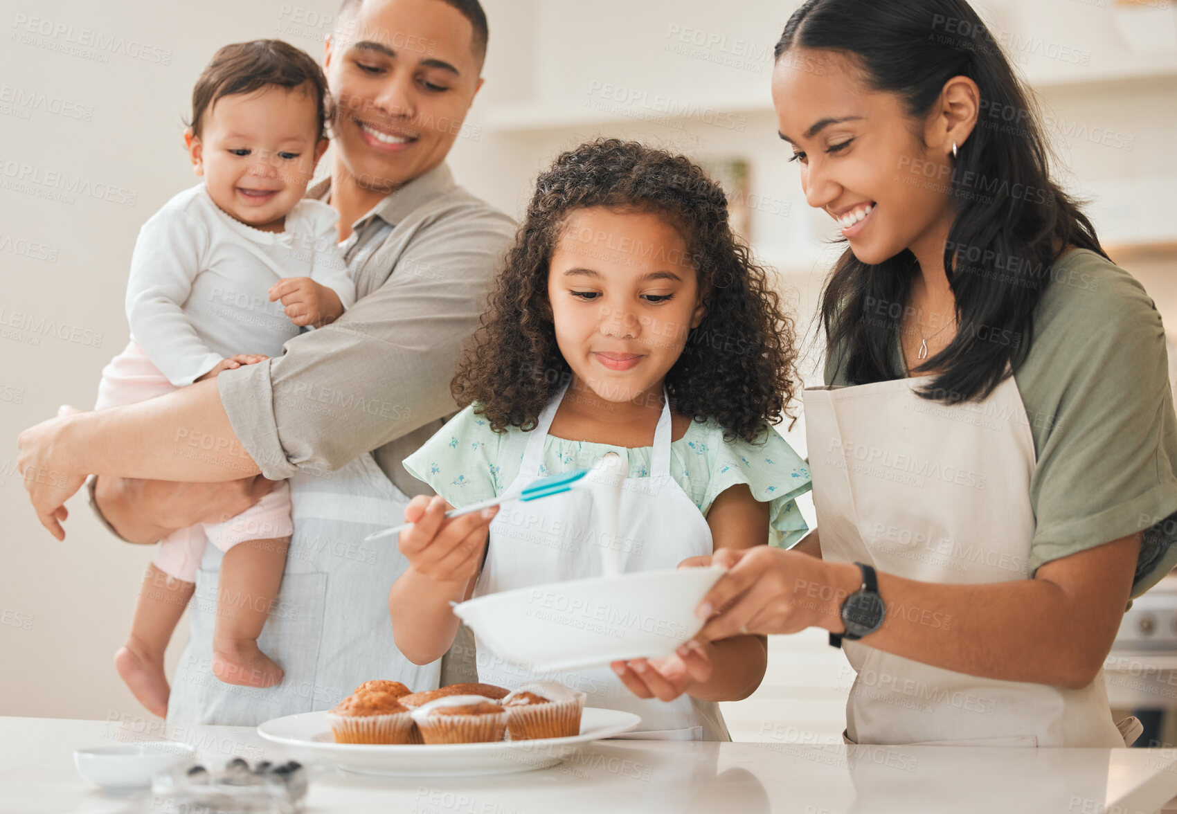 Buy stock photo Baking, parents and children with cake decoration in kitchen for support, learning and teaching muffin recipe in home. Happy family, people and prepare dessert for cooking education, bonding or skill