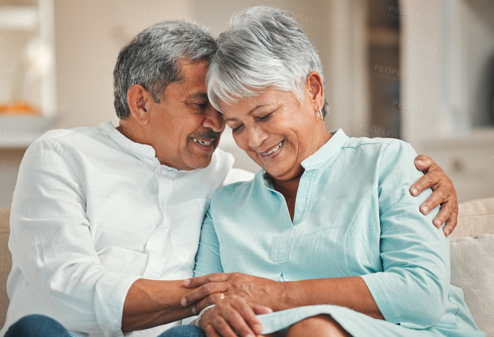 Buy stock photo Laughing, hug and senior couple in living room, chat and bonding of old man and woman with love. Lounge, sofa and embrace of elderly people with commitment to marriage, care and support in house