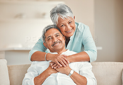 Buy stock photo Senior couple, sofa and portrait with hug, smile and love in home living room with care, romance and happiness. Elderly man, old woman and embrace by lounge couch in retirement together in house