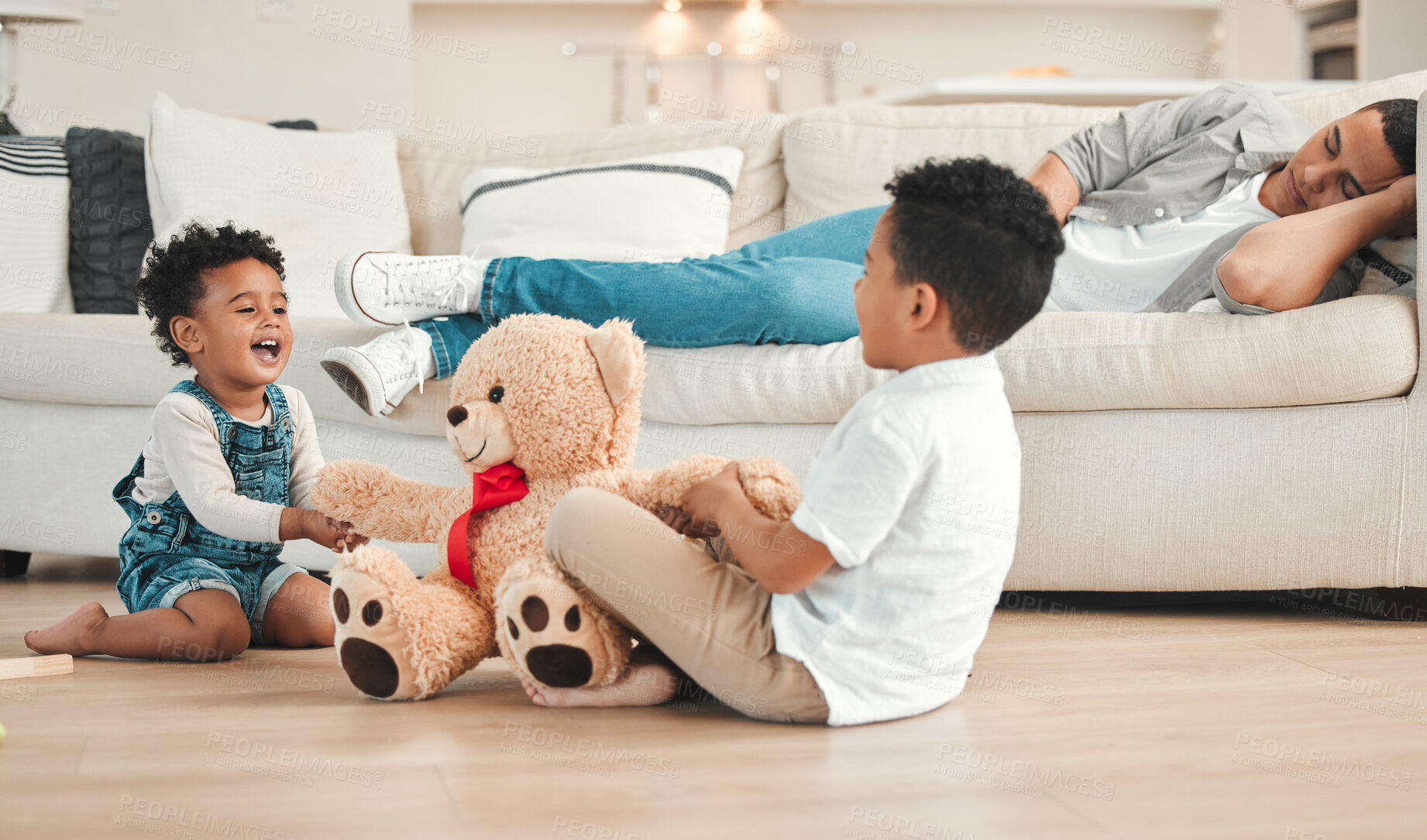 Buy stock photo Fighting, sibling rivalry and teddy bear with children on floor of living room in home for argument. Anger, challenge or shouting with brother kids wresting for control of stuffed animal toy