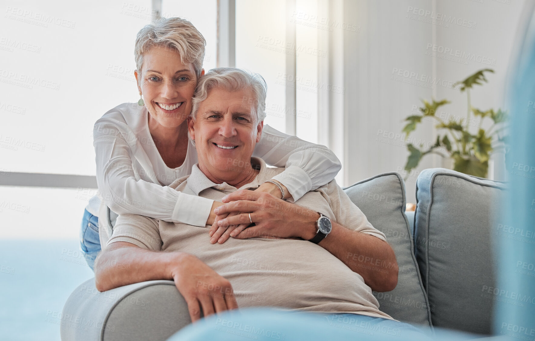 Buy stock photo Cropped portrait of an affectionate senior couple relaxing in their living room at home