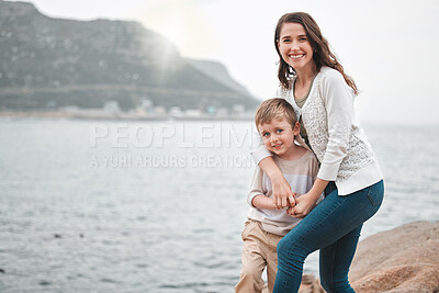 Buy stock photo Shot of a happy mother and son enjoying a day along the coast