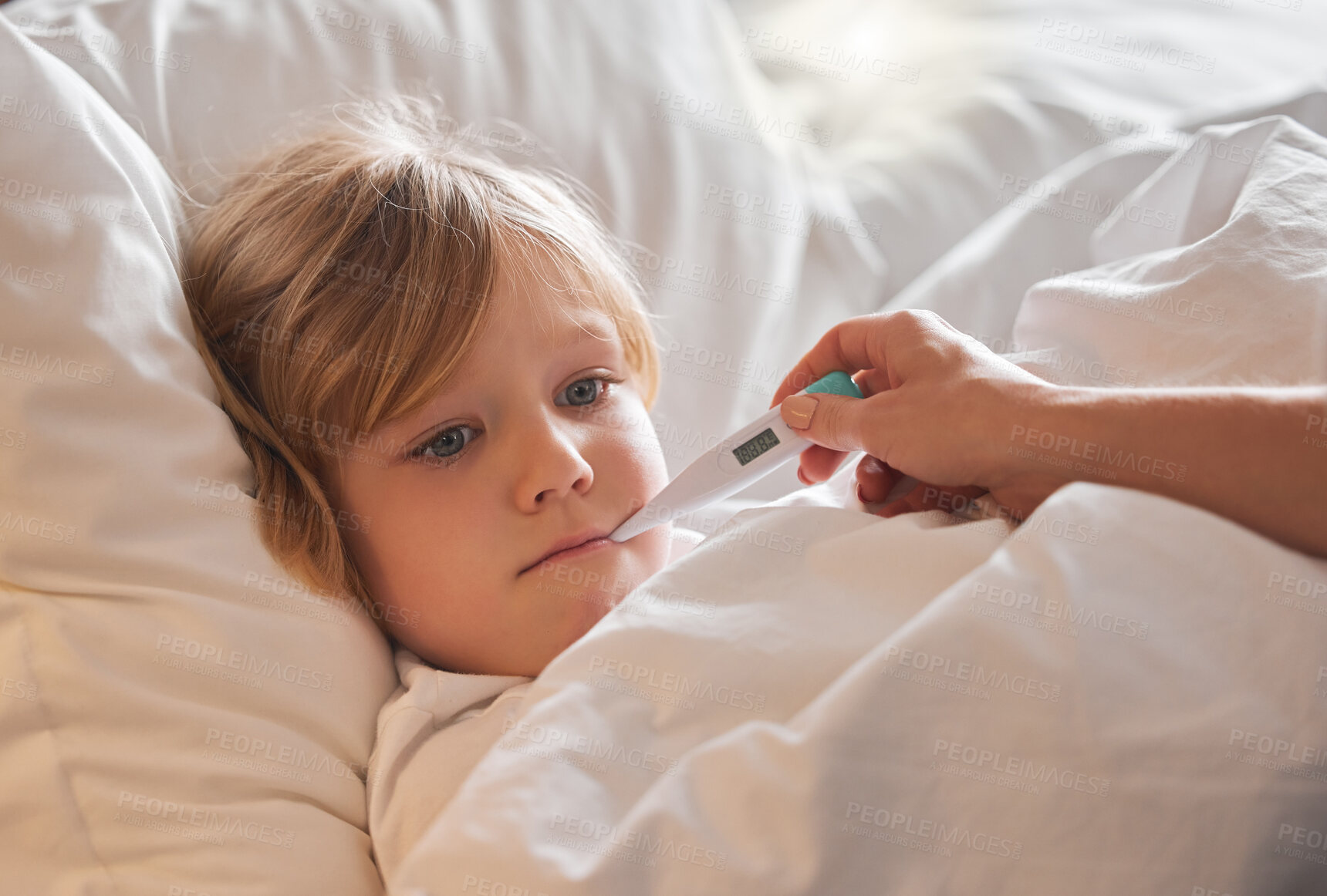 Buy stock photo Shot of an unrecognisable woman taking a little girl’s temperature with a thermometer in bed at home