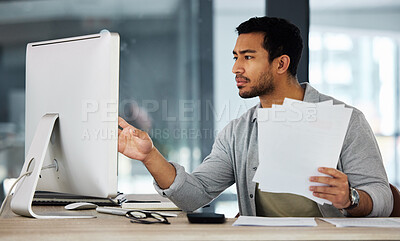 Buy stock photo Shot of a young businessman working with important paperwork