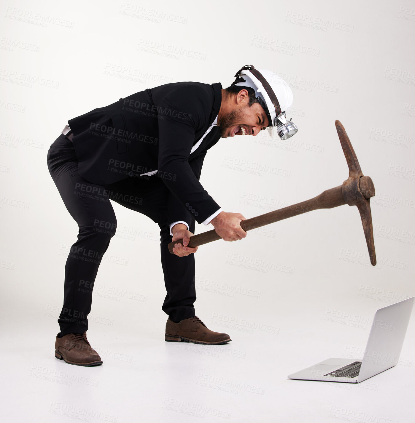 Buy stock photo Angry, pickaxe and businessman in studio with laptop for cryptocurrency, stock trading or investment. Frustrated, white background and person with computer, smash and helmet for debt, money or mining