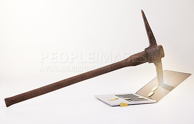 Buy stock photo Shot of a pick hitting the screen of a laptop against a white background