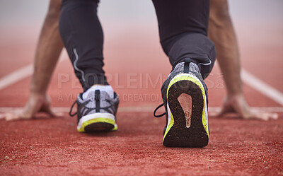 Buy stock photo Rearview shot of an unrecognizable young male athlete running on an outdoor track