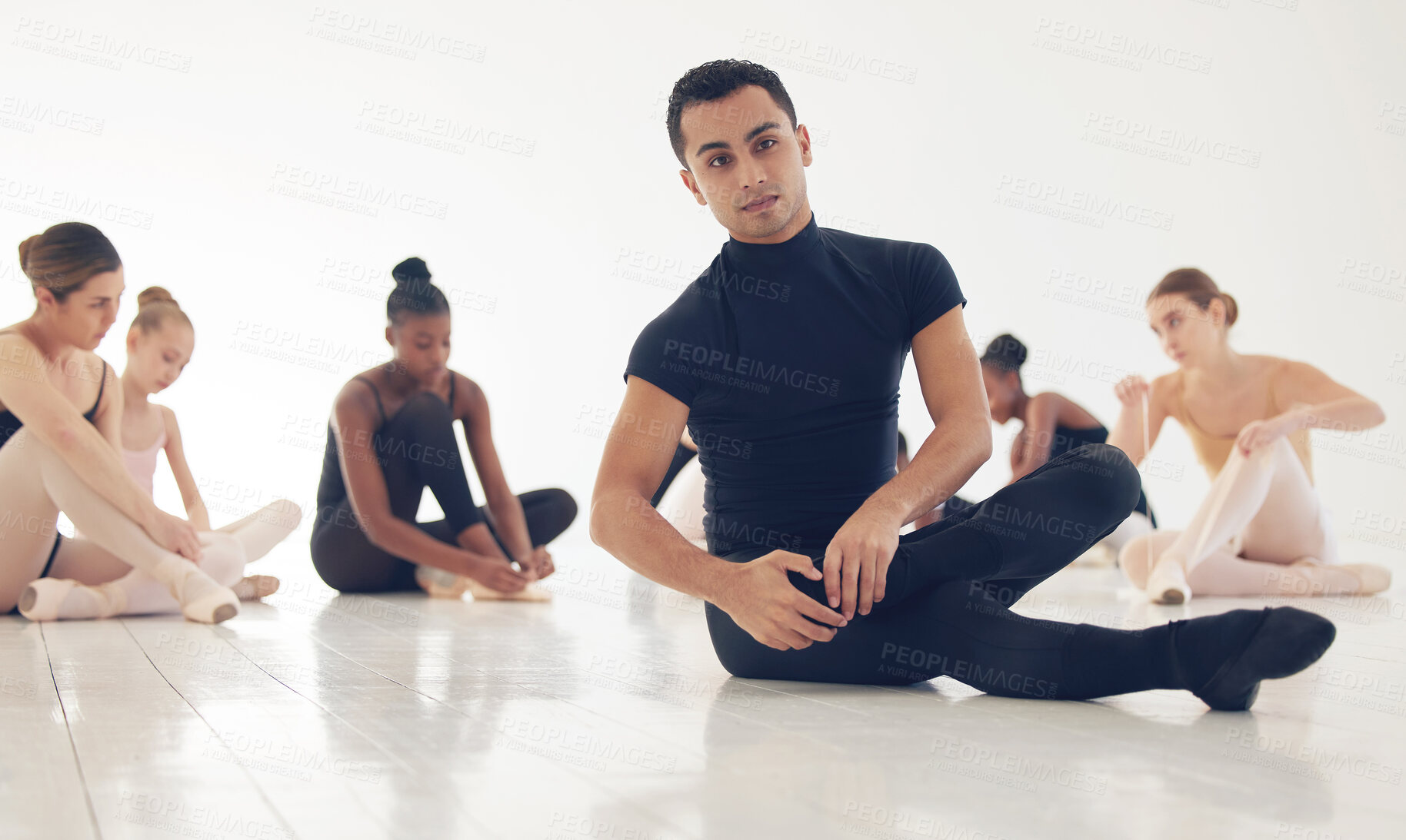 Buy stock photo Ballet, man and students stretching on floor together for practice, exercise or flexibility. Art, dance studio and wellness, group of people warm up for fitness or creative performance in classroom