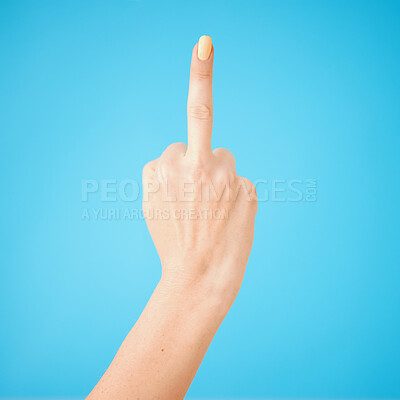 Buy stock photo Studio shot of an unrecognisable woman showing her middle finger against a blue background