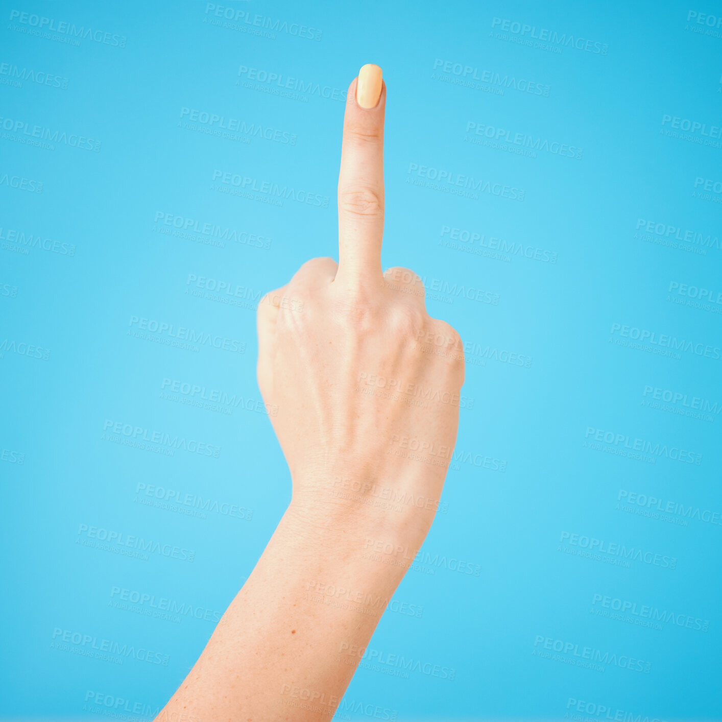 Buy stock photo Rude, woman and hand with middle finger in studio for bad review, offended and angry on blue background. Conflict, sign language and emoji with gesture for rejection, fake news and negative opinion