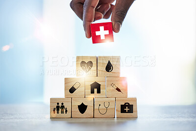 Buy stock photo Hand, building blocks and man with cross, medical or icons for investment, security and insurance. Finger, choice and male with puzzle for healthcare, family or asset management, safety or planning