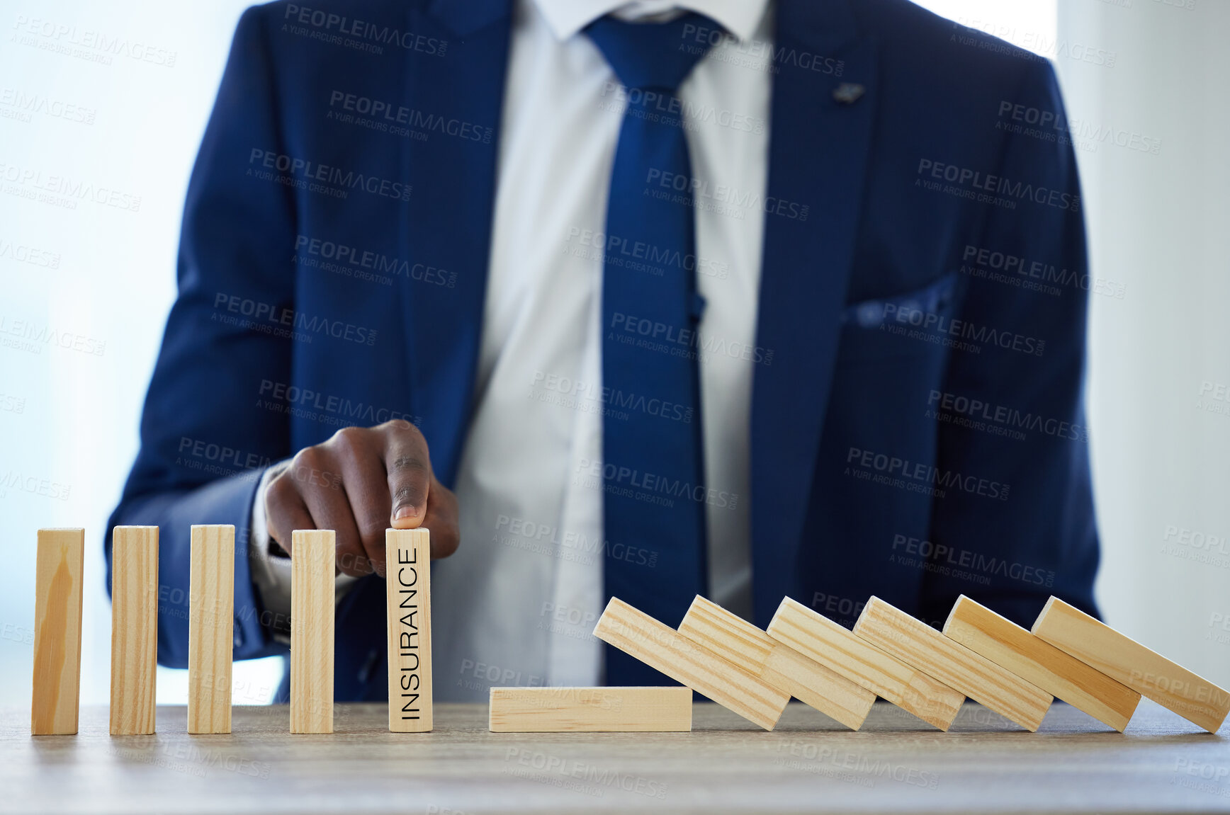 Buy stock photo Insurance, business person and wooden blocks in office for protection, financial trust or problem solving. Black man, toy pieces or pointing hand for selection, advice or decision for corporate cover