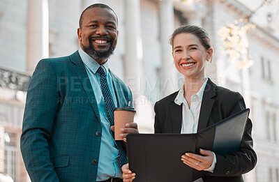 Buy stock photo Shot of two colleagues going through a file in the city