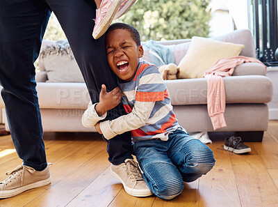 Buy stock photo Tantrum, home and boy on leg of father shouting with anger, frustrated and upset emotions. Family, discipline and naughty child holding parent scream with mess, clothes and chaos in living room