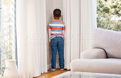 Buy stock photo Shot of a little boy standing in the corner as a punishment at home