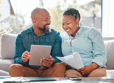 Buy stock photo Finance, married couple with tablet and documents for pay their bills online n a living room of their home. Technology or loan, budget or payment and happy people with paper on a couch together