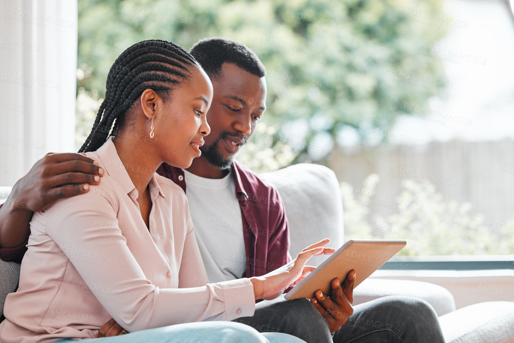 Buy stock photo People, black couple and smile with tablet on sofa at home with browsing internet for house insurance options. Family, relationship and happy or satisfied on website for life policy and funeral cover