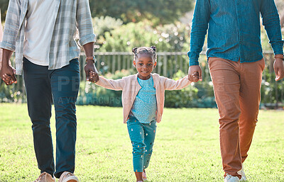 Buy stock photo Shot of an adorable little girl spending time outdoors with her parents