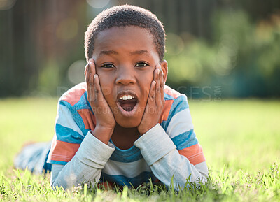 Buy stock photo Black boy, portrait or surprise in park on grass on holiday, weekend or vacation for discount announcement. Lawn, field or face of shocked kid alone in nature excited by happiness or playing in Kenya