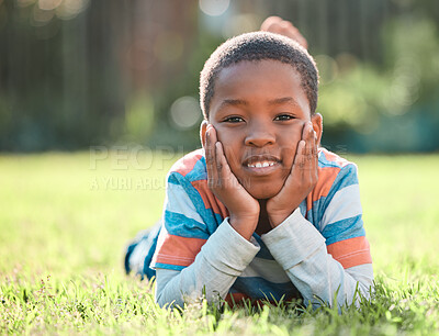 Buy stock photo Nature park, portrait of black boy and lying on grass outside. Summer vacation or holiday break, happiness or cheerful and barefoot with young male person relaxing on a field outdoors on lawn