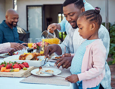 Buy stock photo Outdoor, black family and food with help, girl and bonding together with conversation. House, parents or healthy meal in garden, celebration or cheerful with nutrition, eating or social gathering