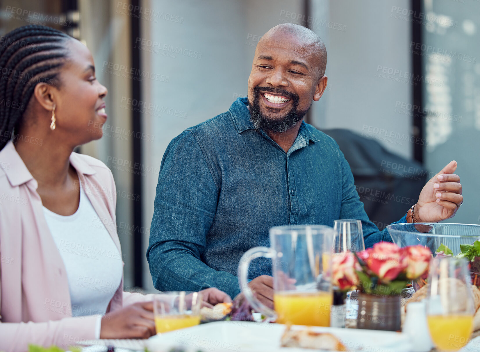 Buy stock photo Outdoor, black couple or food with event, conversation or bonding together with discussion. Group, party or healthy meal in garden, celebration or happiness with nutrition, house or social gathering